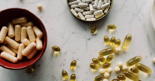 Assorted magnesium supplement capsules and powder on a clean surface, illustrating a magnesium buying guide UK for 2026.