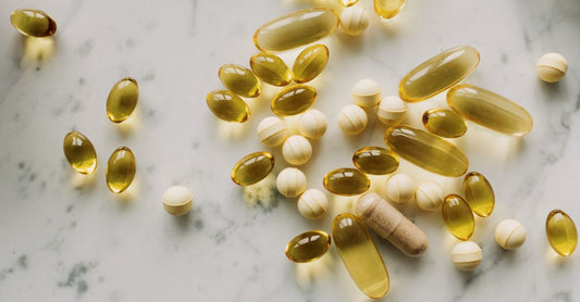 Three vitamin B12 supplement bottles on a white surface, illustrating the B12 buying guide UK