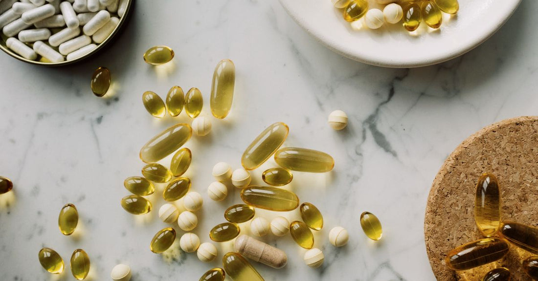 A white bottle of best resveratrol UK 2026 supplements placed on a clean kitchen worktop next to a glass of water and a spoon, representing a daily morning routine.