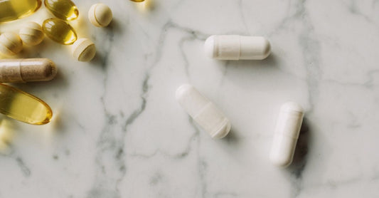 Vitamin K2 MK7 90 mcg supplement bottle on a clean white surface, showcasing the label and softgel capsules.