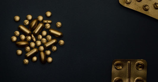 A bottle of best B9 (folic acid) UK 2026 supplements on a clean white surface with a few tablets scattered nearby