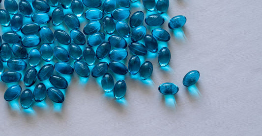 A cluster of golden eye health supplement capsules on a white surface, representing the eye health buying guide UK.