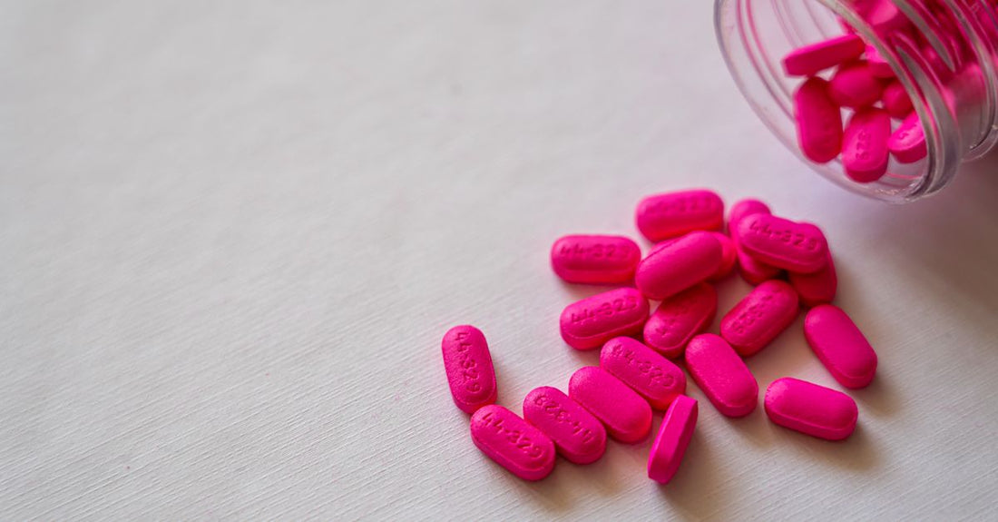 Cranberry supplement capsules on a clean white surface, illustrating how to choose cranberry UK products wisely.