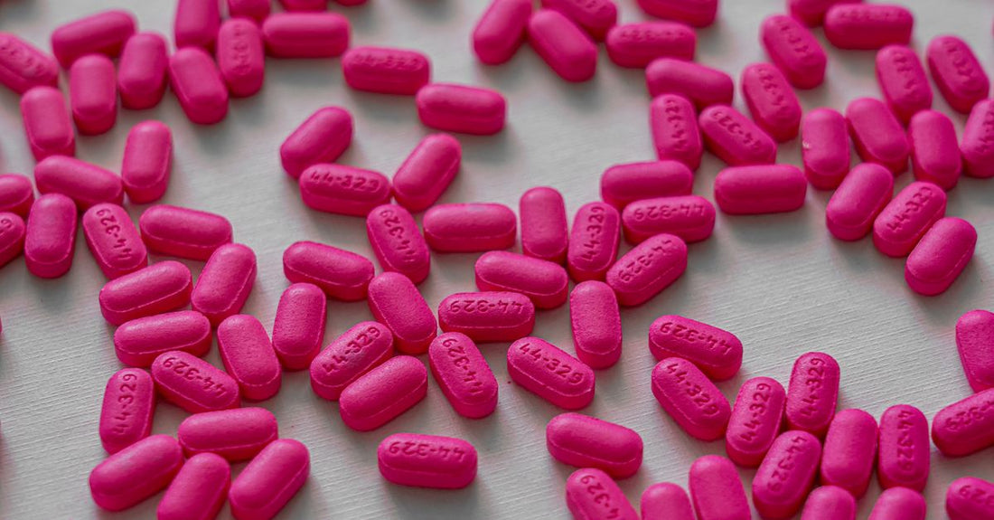 A selection of vitamin B12 supplement bottles and tablets on a clean white surface, representing a B12 buying guide for UK shoppers.