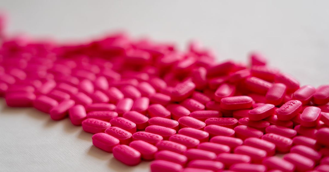 Vitamin B12 supplement bottles and tablets in a clean flatlay arrangement, illustrating a B12 buying guide for UK shoppers.