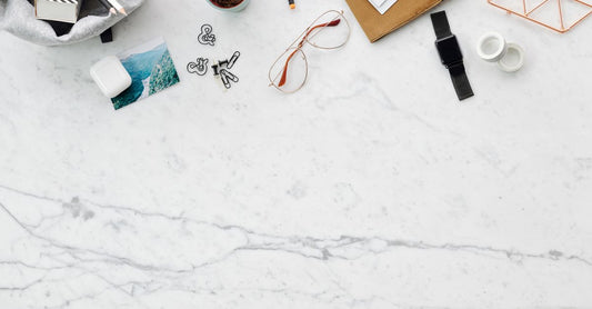 Flatlay of colourful digestive supplement capsules and powder on a white marble surface, illustrating a digestive supplements buying guide UK