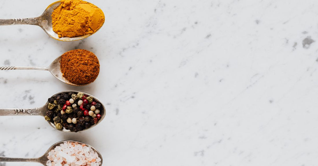 Row of turmeric supplement bottles and capsules on a light background for best turmeric UK 2026 comparison guide.