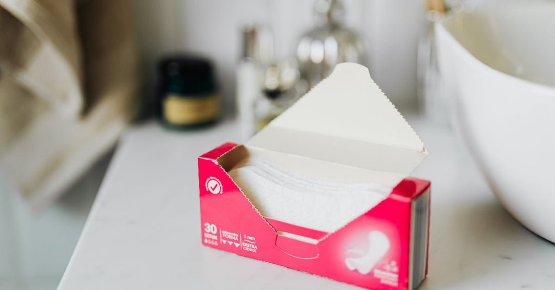 Incontinence pads for women packaging flatlay showing different absorbency levels and organic materials