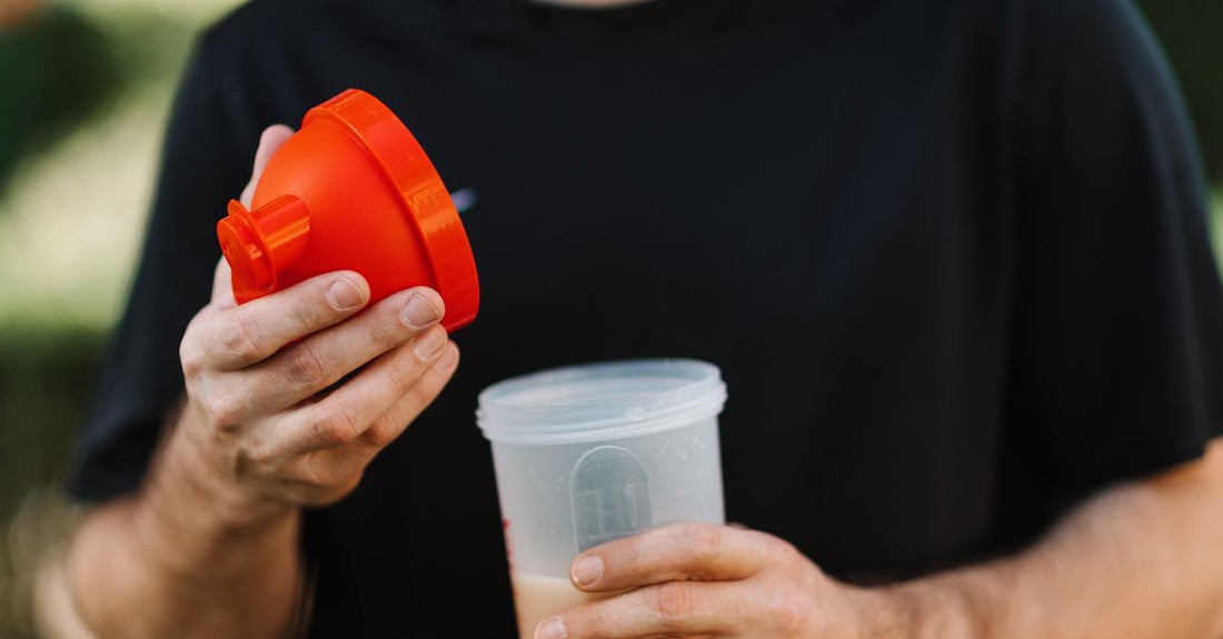 A protein powder shaker bottle beside supplement jars on a clean surface, illustrating a diet & sports nutrition buying guide UK for beginners.