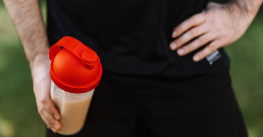 Two BPA-free protein shaker bottles with wire whisk balls on a gym bench, showcasing the best shaker bottles UK 2026