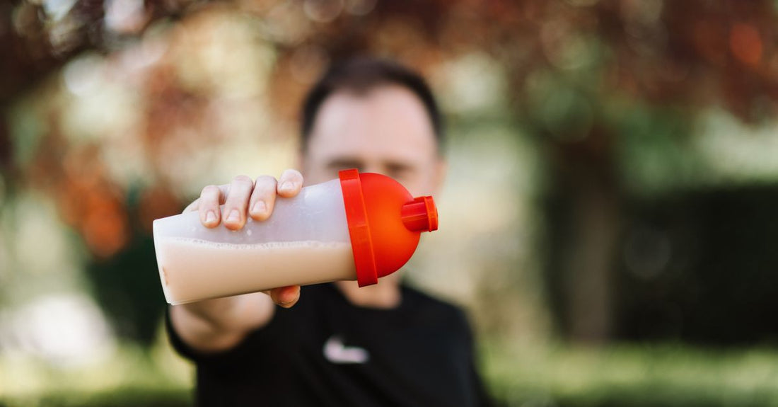 An assortment of sports nutrition products including protein powder, shaker bottles, and energy gels on a white background, illustrating how to choose diet & sports nutrition UK.