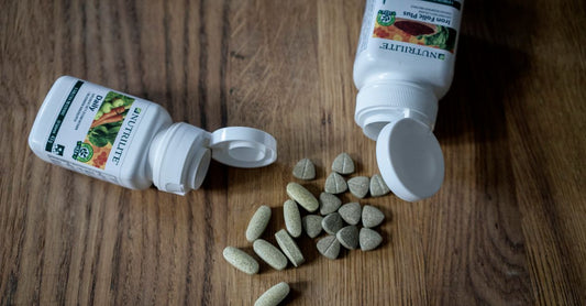 Iron tablets with vitamin C arranged on a clean surface, highlighting supplement pairing for enhanced absorption