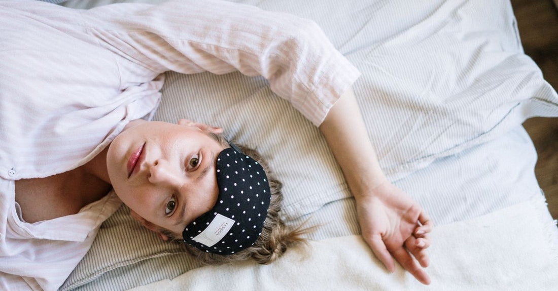 A flat lay of various sleeping masks, including contoured and silk styles, illustrating a sleeping masks buying guide UK