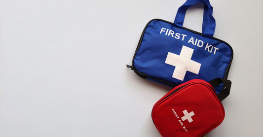How to choose first aid kits UK flatlay showing essential supplies like bandages, scissors, and antiseptic wipes on a clean surface.
