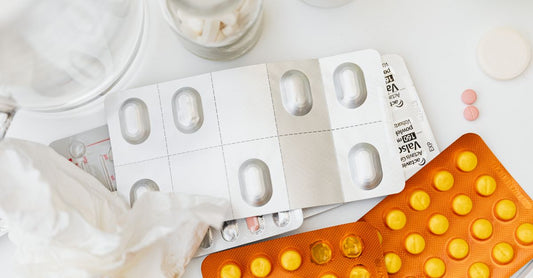 Assorted adhesive bandages in fabric, hydrocolloid, and clear film materials laid out on a clean surface, showing different sizes and textures for wound care comparison.