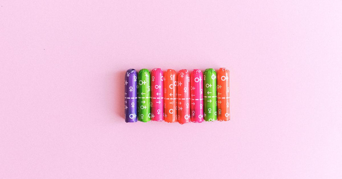 A flatlay of assorted tampons in a neat box, representing a UK tampons buying guide for choosing the right period product.