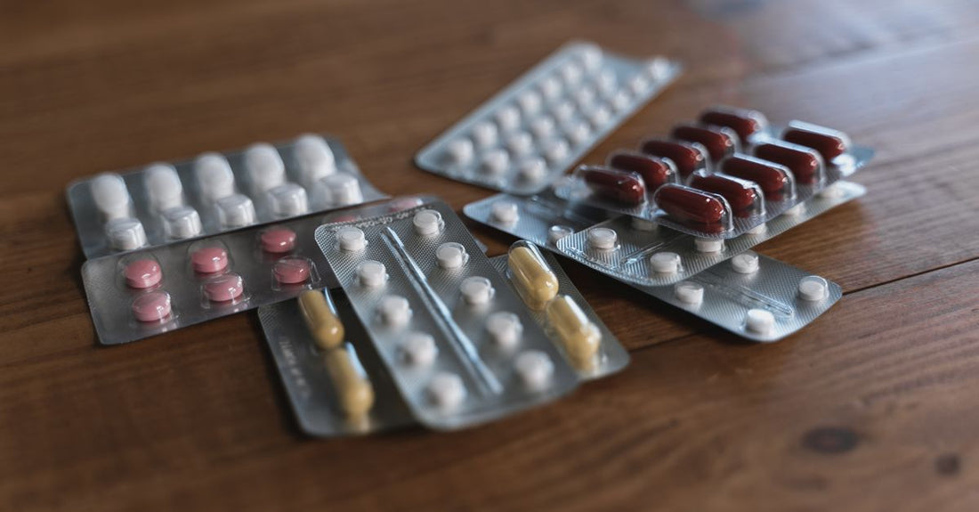 An assortment of supplement capsules and tablets arranged neatly on a light surface, illustrating a supplements buying guide UK.