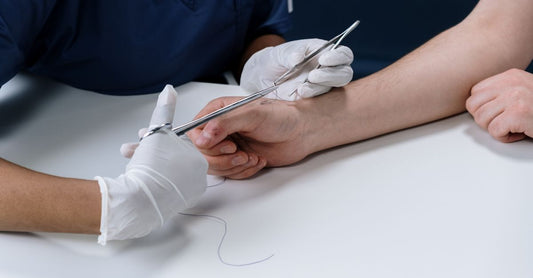 Sterile bandaging pads for first aid arranged on a clean surface, showing non-stick and absorbent layers.