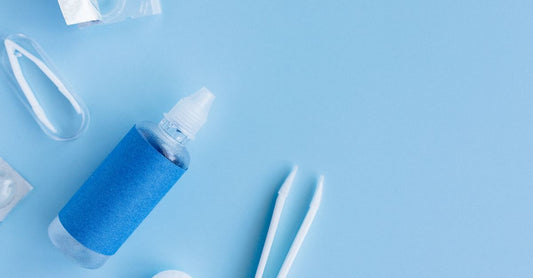 A selection of earwax removal products including drops, an irrigation bulb, and a manual removal tool, laid out on a clean surface for a UK buying guide.