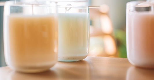 A luxury soy wax candle in a glass jar on a marble surface, illustrating our candles buying guide UK.