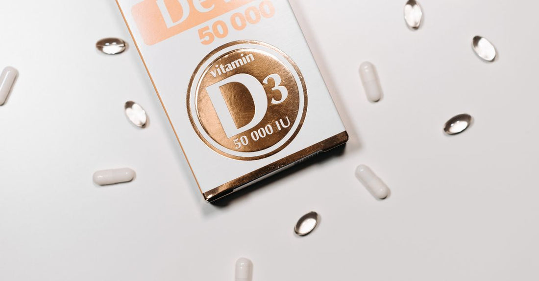 A bottle of vitamin D3 2000 IU tablets placed on a clean white surface with a few tablets scattered nearby, representing a daily supplement routine.