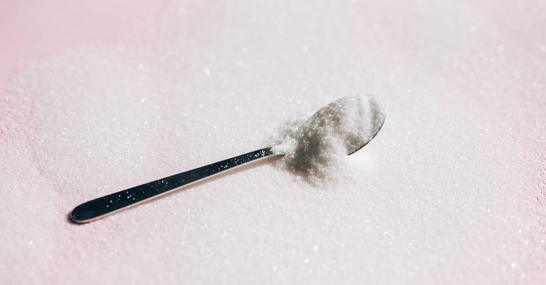 Tub of creatine monohydrate powder on a kitchen worktop, illustrating our creatine buying guide UK for seamless daily integration.
