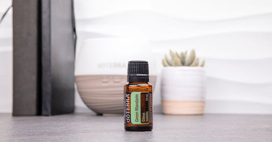 Collection of essential oils for relaxation in amber bottles with a diffuser on a calm, neutral background, reflecting a soothing aromatherapy setup.