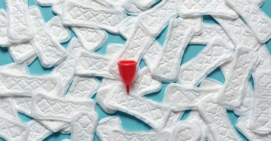 A medical-grade silicone menstrual cup placed on a soft grey background, illustrating our menstrual cups buying guide UK.