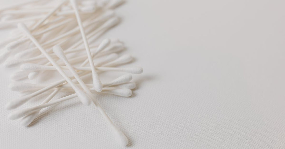 Assorted cleansing cloths, cotton swabs and wipes arranged on a light surface for a cleansing cloths, swabs & wipes buying guide UK