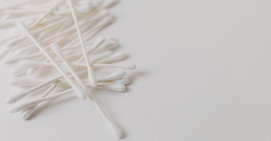 Assorted cleansing cloths, cotton swabs and wipes arranged on a light surface for a cleansing cloths, swabs & wipes buying guide UK