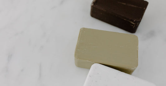Natural insect bite relief products including calamine soap bar and bug bite balm on a clean background.