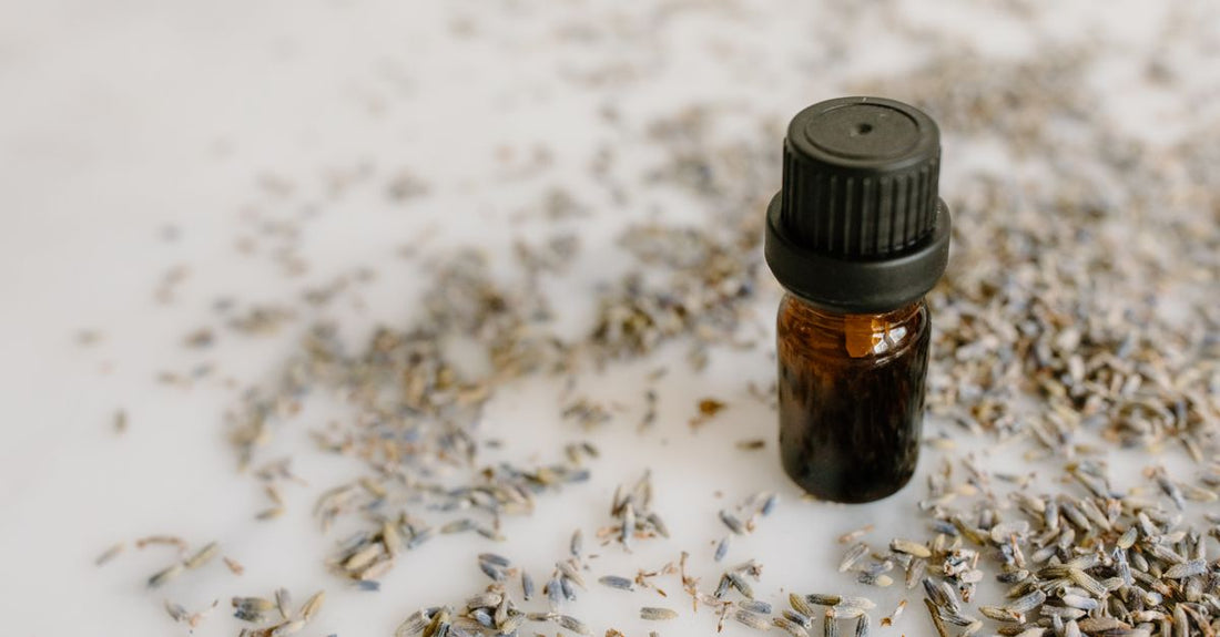 Lavender essential oil for sleep bottle on a bedside table with diffuser