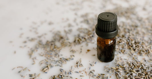 Lavender essential oil for sleep bottle on a bedside table with diffuser