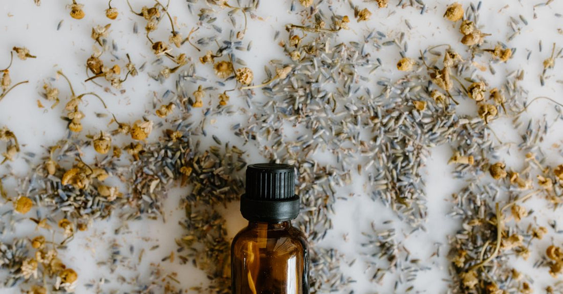 A bottle of organic flaxseed oil beside a small bowl of whole brown flax seeds on a light wooden surface, representing the best flaxseed UK 2026 options.