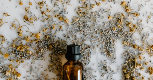 A bottle of organic flaxseed oil beside a small bowl of whole brown flax seeds on a light wooden surface, representing the best flaxseed UK 2026 options.