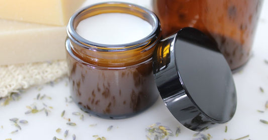 A row of traditional ayurvedic balm jars on a wooden shelf, showcasing natural ingredients for this ayurvedic balms & ointments buying guide.