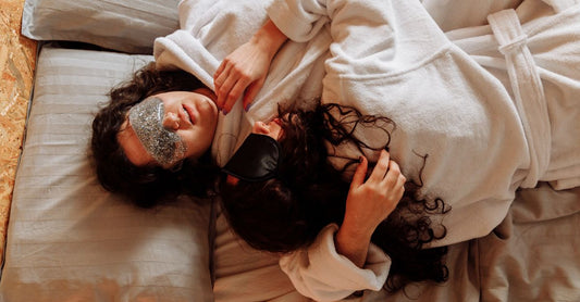A blackout contoured sleep mask lying flat on a neutral surface, illustrating how to choose sleeping masks UK.