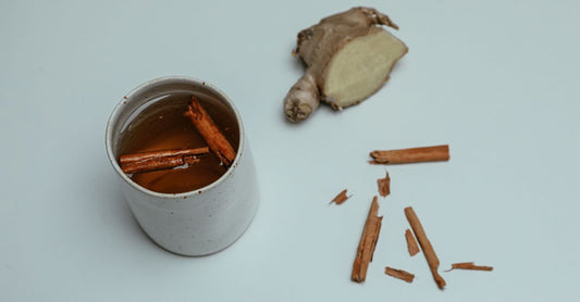 Cup of dandelion root tea detox with fresh dandelion flowers on rustic table
