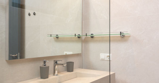 A selection of the best drain pouches UK 2026 displayed on a clean bathroom shelf, showcasing different brands and closure types for ileostomy and colostomy care.