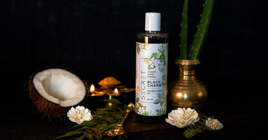 Bottles of Ayurvedic hair oils and herbal hair care products on a wooden shelf, representing how to choose Ayurvedic hair care in the UK.