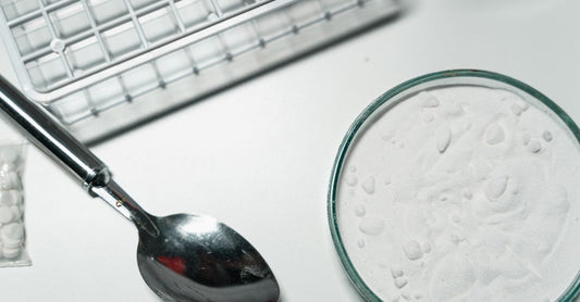 A bottle of potassium supplement capsules next to a glass of water, representing the best potassium UK 2026 safety guide.
