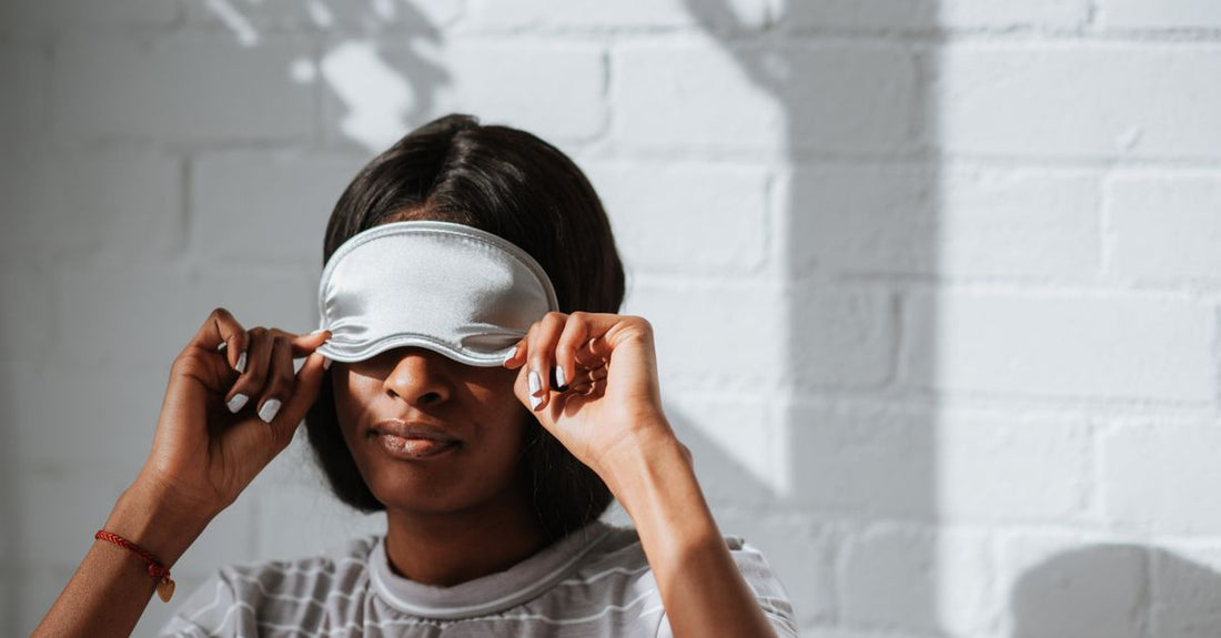 A flatlay of various sleep masks on a neutral surface, illustrating a sleeping masks buying guide UK