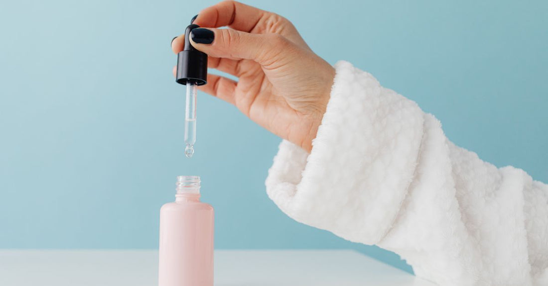 A glass bottle of liquid trace mineral drops next to a small amber jar on a white shelf, illustrating a trace minerals buying guide UK supplement choice.
