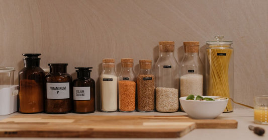 Assorted vitamin and supplement bottles arranged on a bright kitchen counter, representing best health care UK 2026 routine integration.