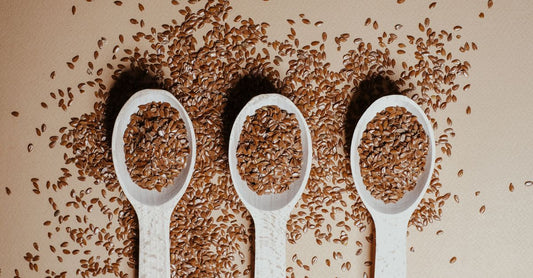 A glass jar of golden flaxseed on a rustic wooden table, how to choose flaxseed UK guide