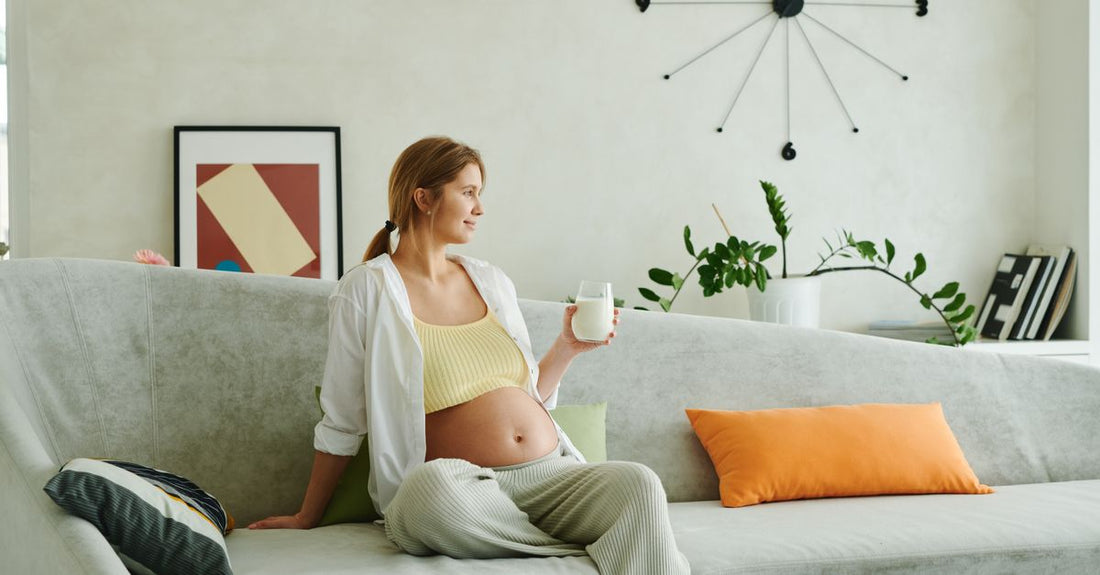 A flatlay of prenatal vitamin bottles and capsules on a light wooden surface, illustrating a prenatal vitamins buying guide UK.