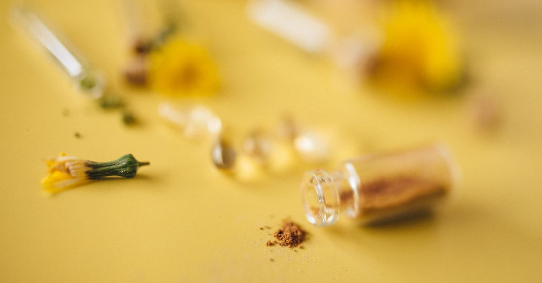 Assorted herbal supplement capsules and dried herbs on a clean surface, illustrating an herbal supplements buying guide UK.