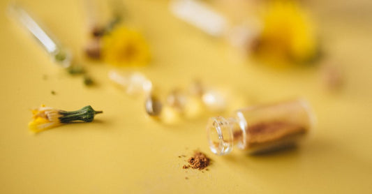 Assorted herbal supplement capsules and dried herbs on a clean surface, illustrating an herbal supplements buying guide UK.