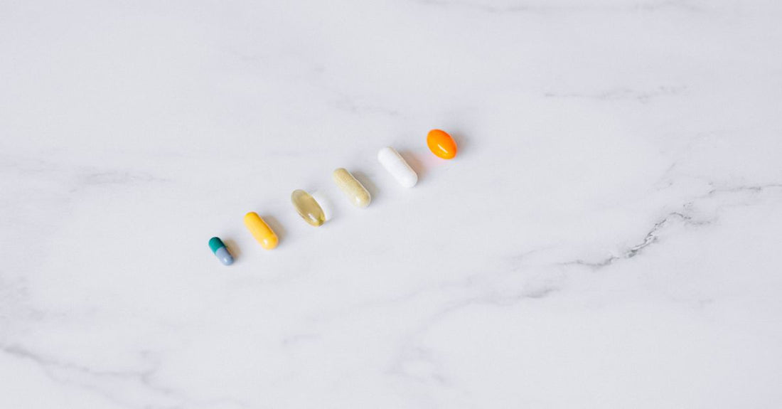 Variety of vitamin and mineral supplement bottles arranged on a light background, illustrating a combinations buying guide UK.