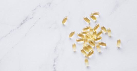 Calcium magnesium zinc supplement capsules on a clean white surface.